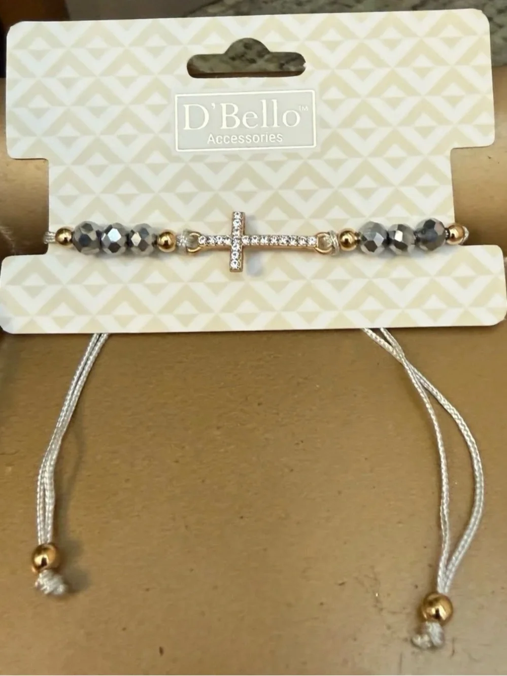 New D'Bello simulated  diamond, gold toned cross with beads bracelet.  Light gra